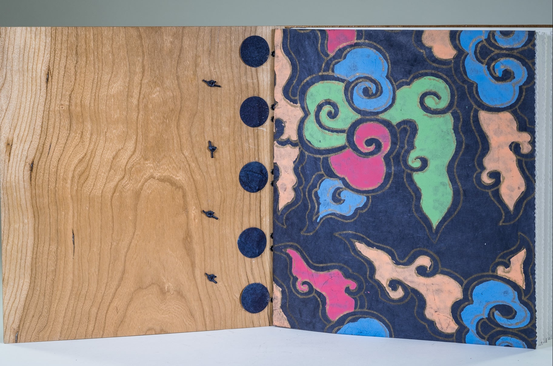 wood covers, drawing paper bound on leather cords, hand-hammered metal hardware, with Nepalese first and last pages