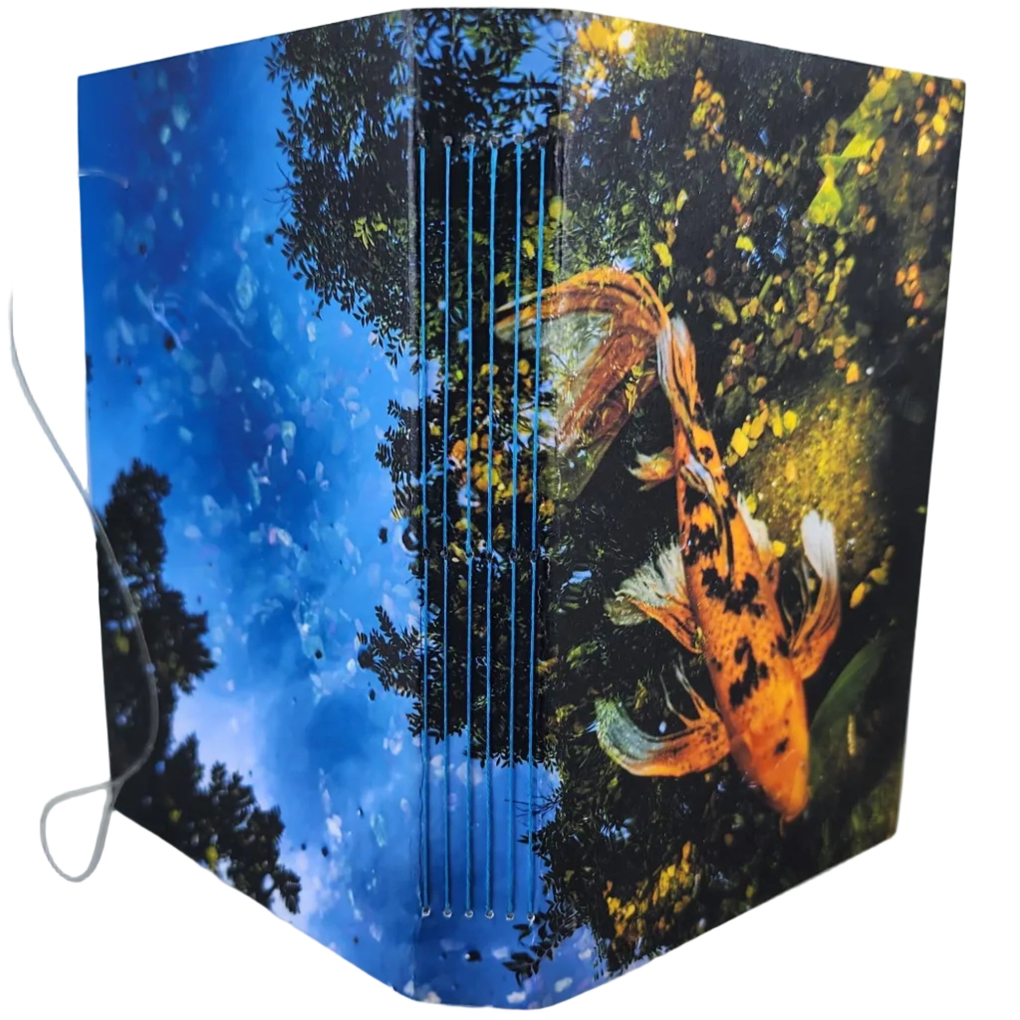 Cover of a Perpetual Calendar Diary (366 dates with no year) is an orange koi swimming in the reflection of sky and trees. ~4x5.5" with 192 pages. Designed and printed in-house and-made with French-link binding.