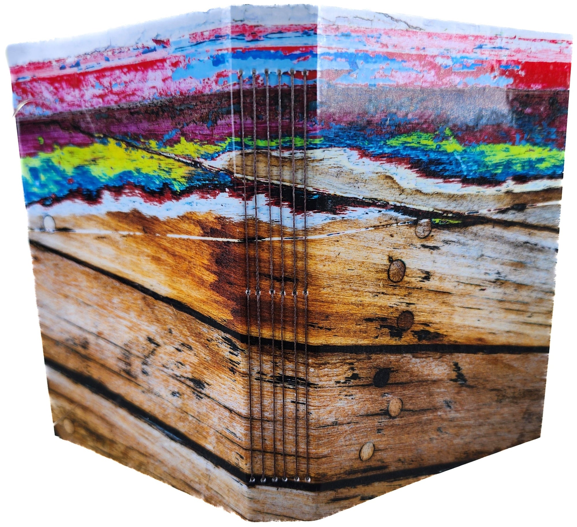 Book covers are a colorful abstract design that's actually many layers of paint being removed from the hull of a wood boat.
