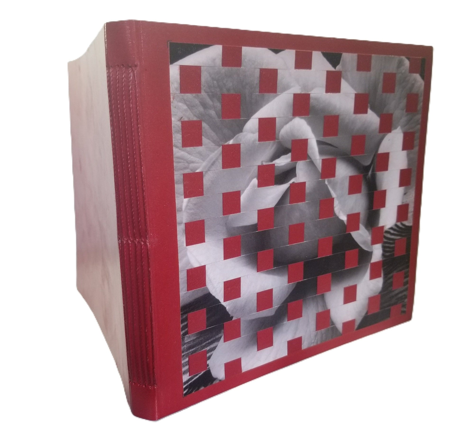 Red-bound book with a black and white geometric pattern on the cover