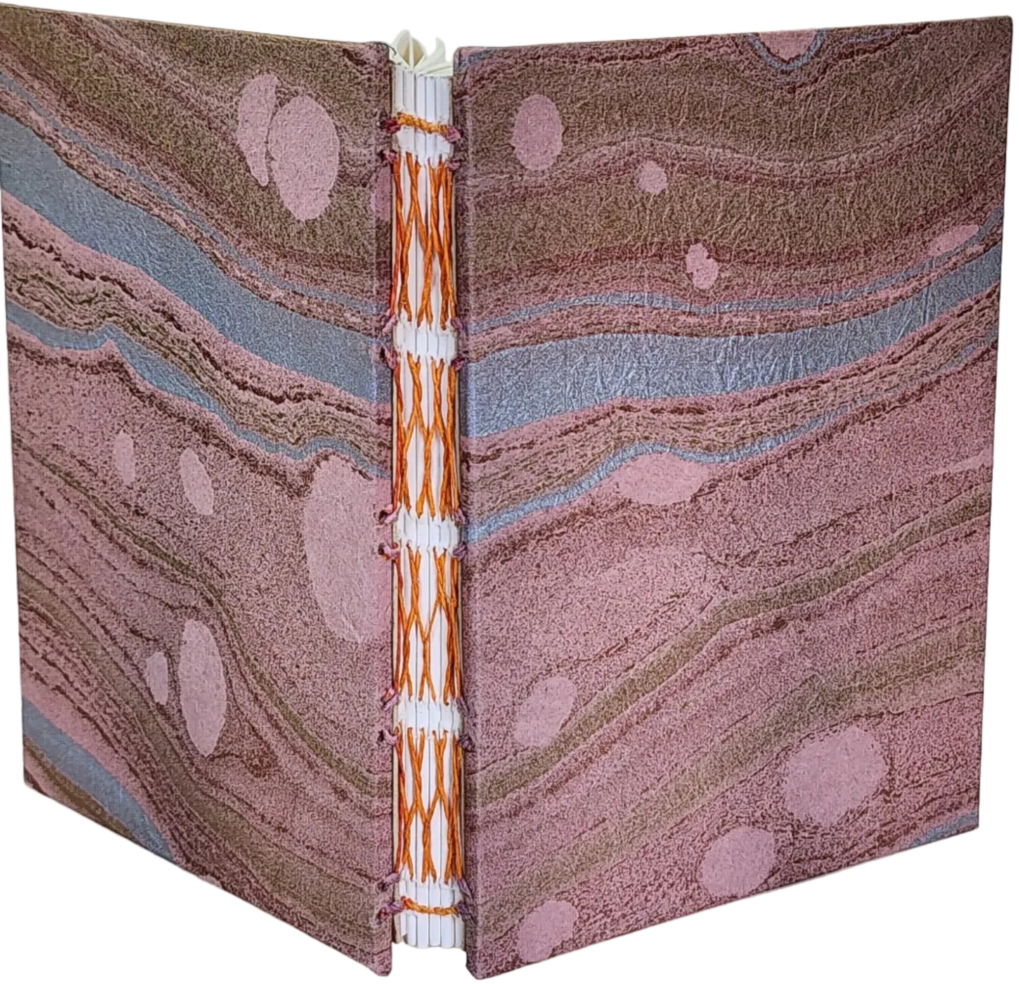 Handmade journal with mulberry (kozo) paper covers, in a pink and gold marbled pattern, and six signatures bound with an orange French-link stitch. 4.25x5.5, 144 pages.