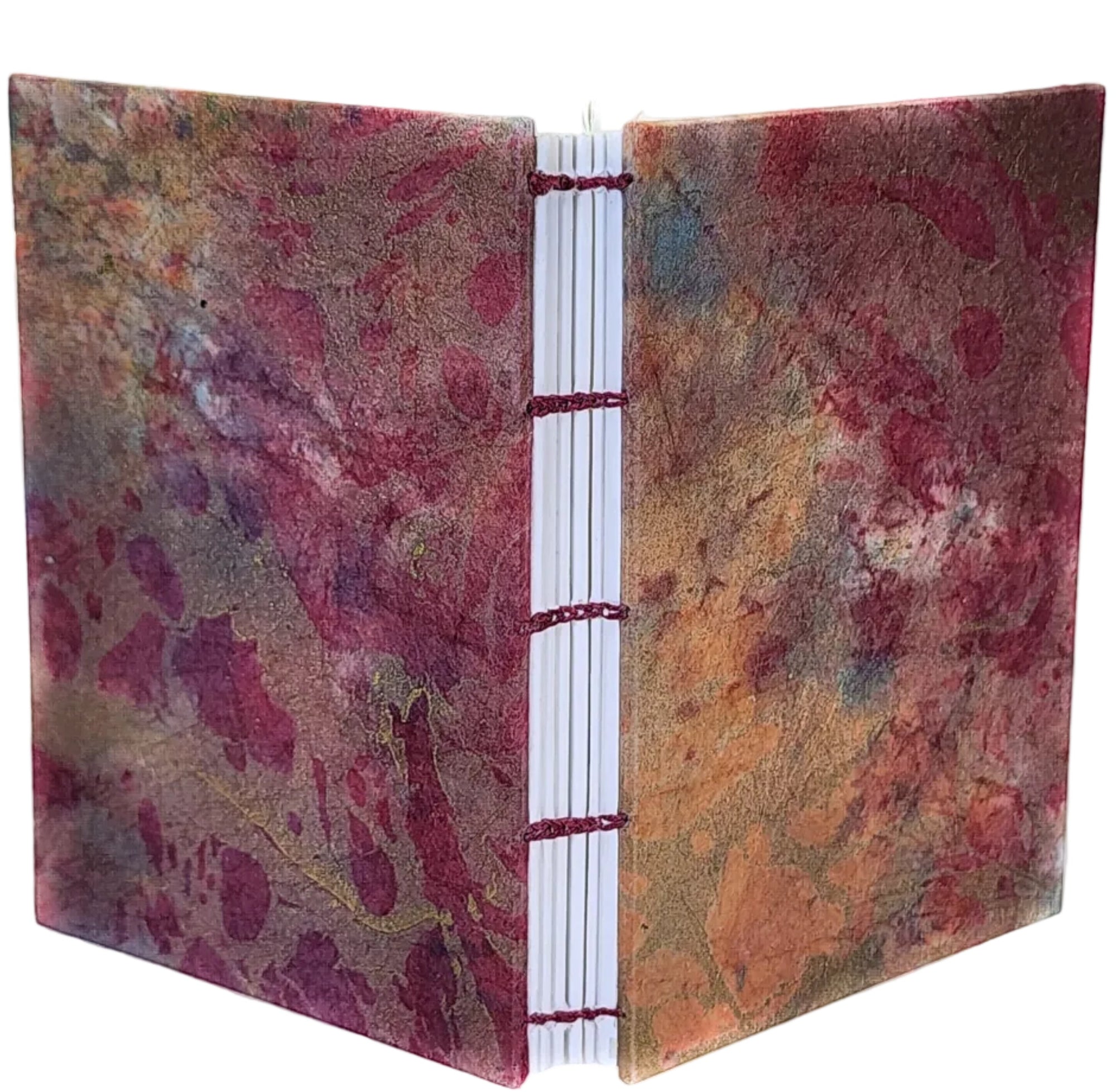 Handmade journal with mulberry (kozo) paper covers, in a marbled pattern of pink and gold, and six signatures bound with a matching color thread using a coptic stitch. ~4×5.5" 116 pages