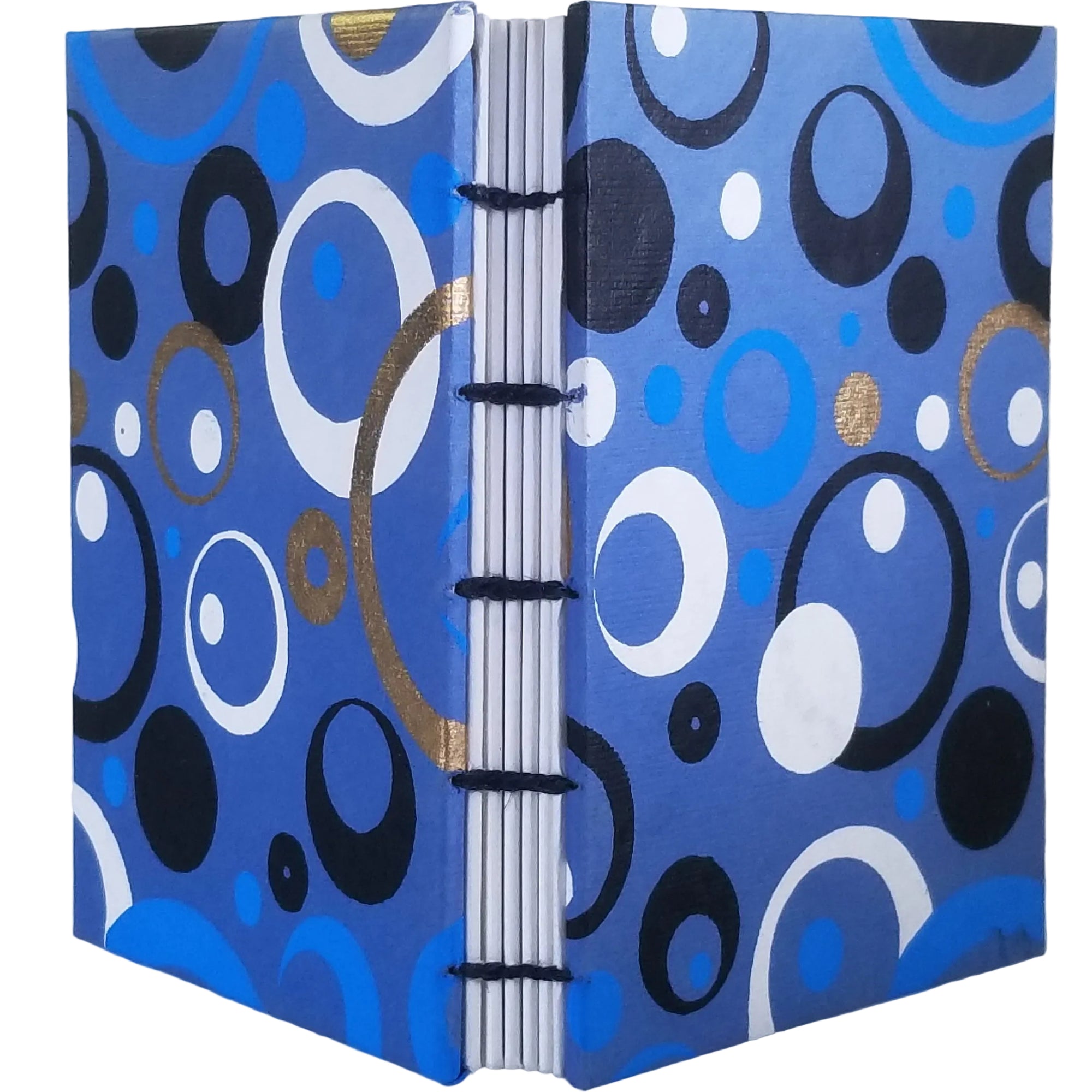 Handmade journal with blue plant-based paper on the covers in an abstract pattern of white, gold, and black rings and circles; six signatures of white drawing paper; and coptic-bound with waxed linen thread. ~4×5.5" and 116 pages