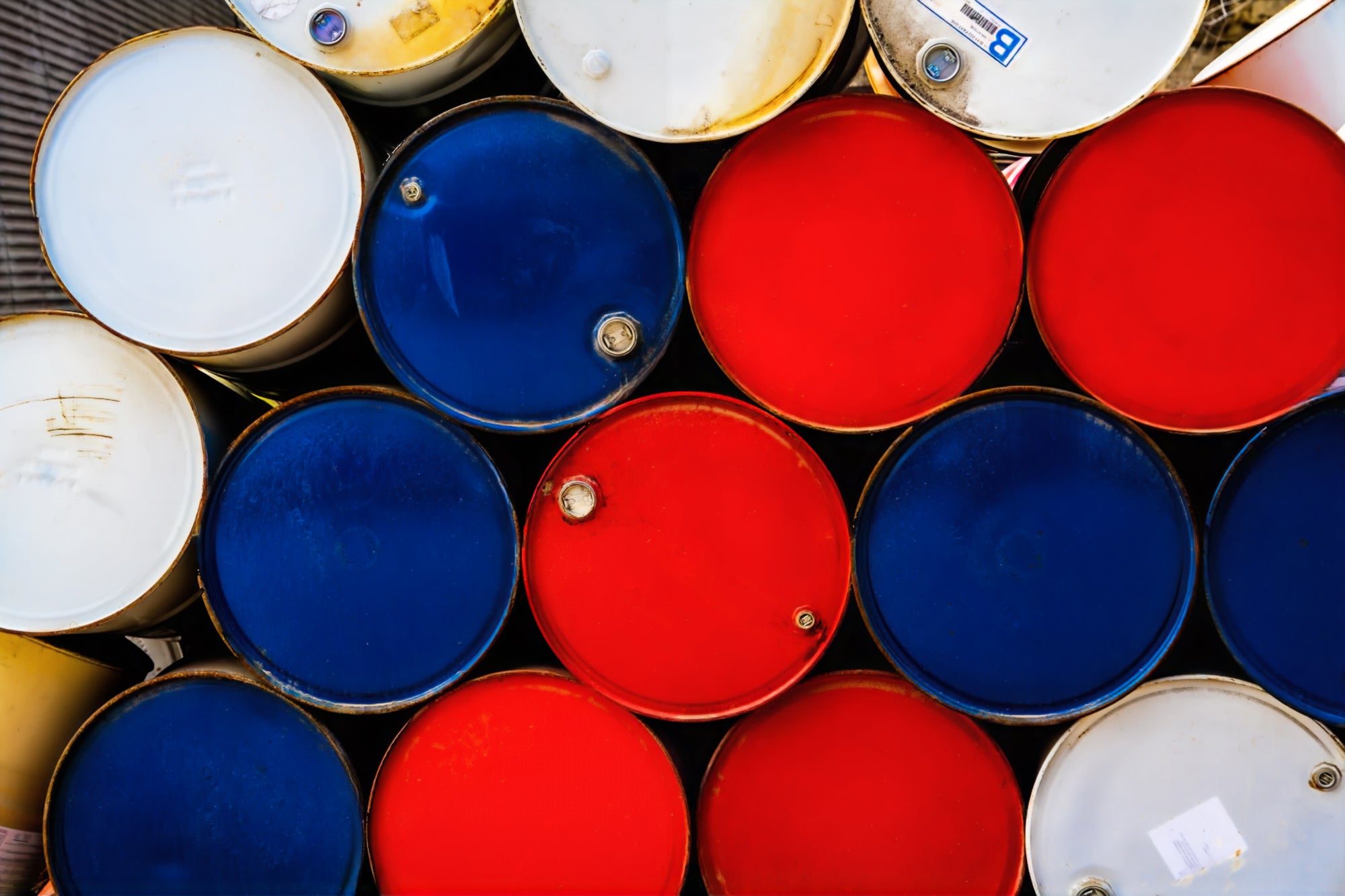 Stack of red, white, and blue oil drums; photographer Rick Graves