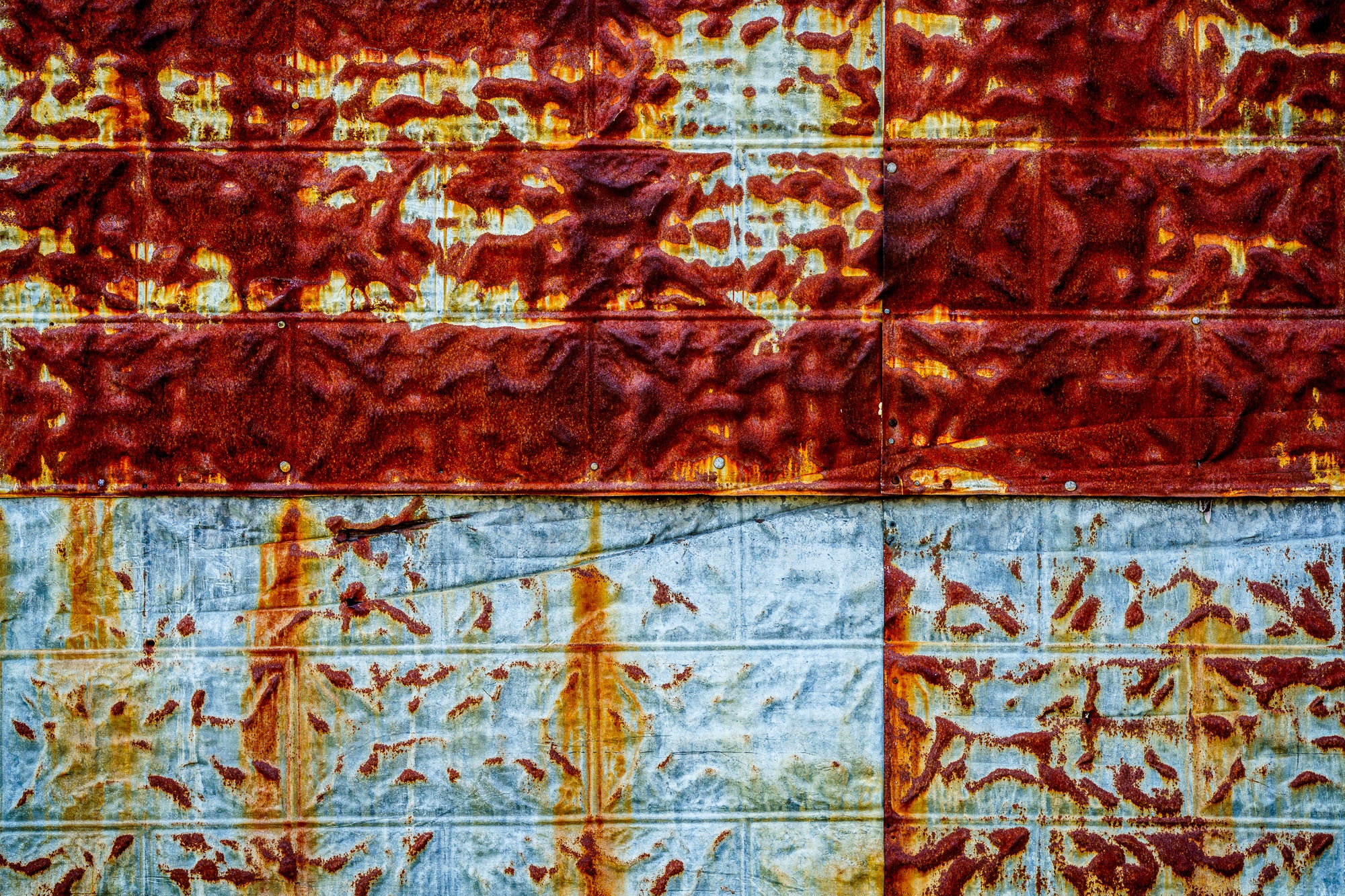 Rust patterns on pressed tin siding; photographer Rick Graves