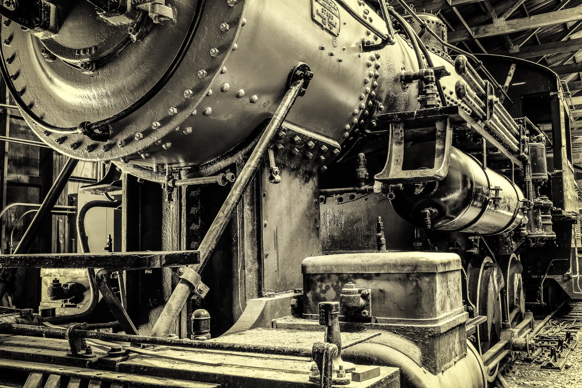 Large vintage locomotive steam engine in a repair shed; photographer Rick Graves