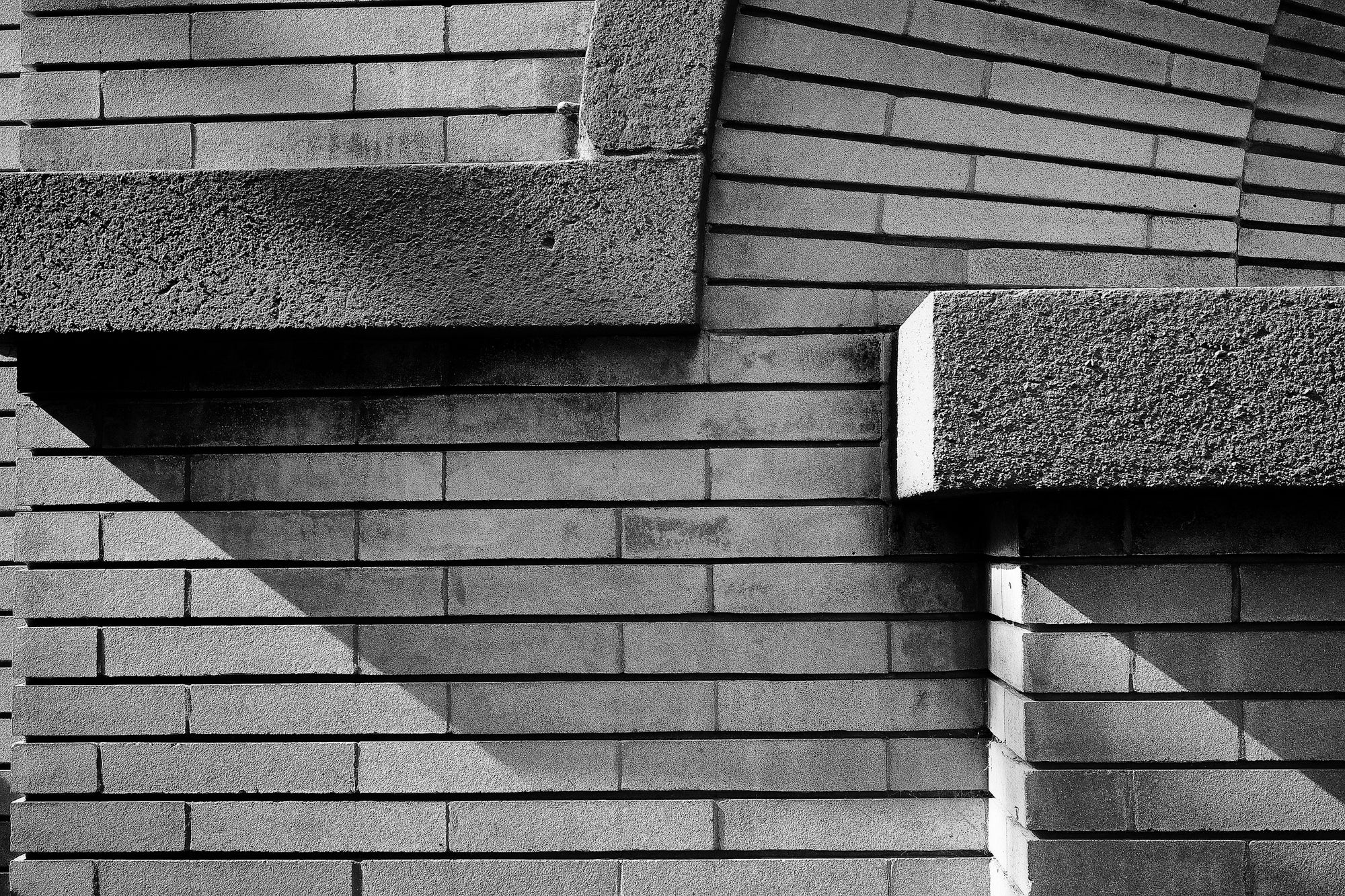 Close-up of a brick wall with concrete accents; photographer Rick Graves