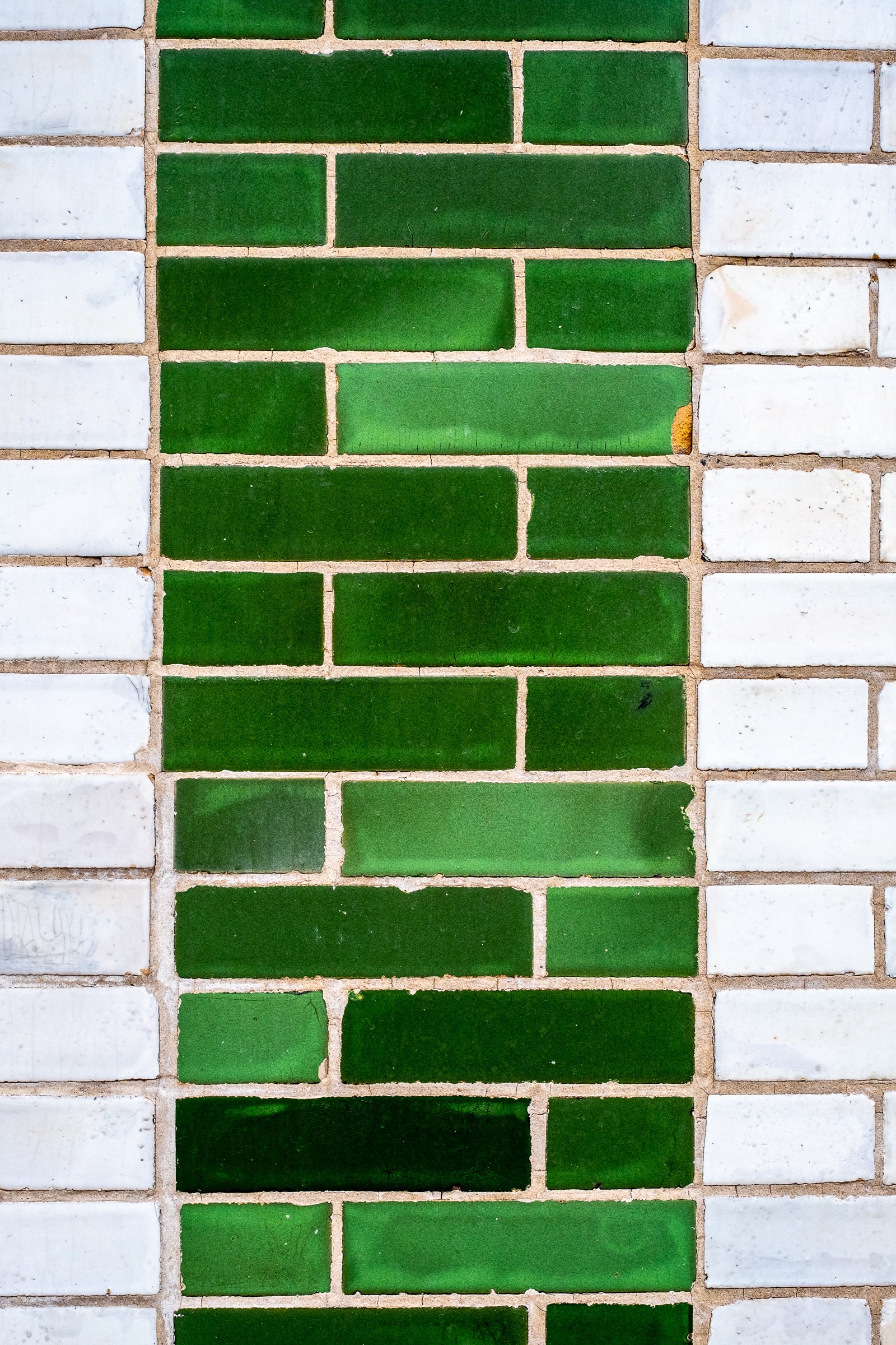 Wall with a pattern of green and white glazed bricks; photographer Rick Graves