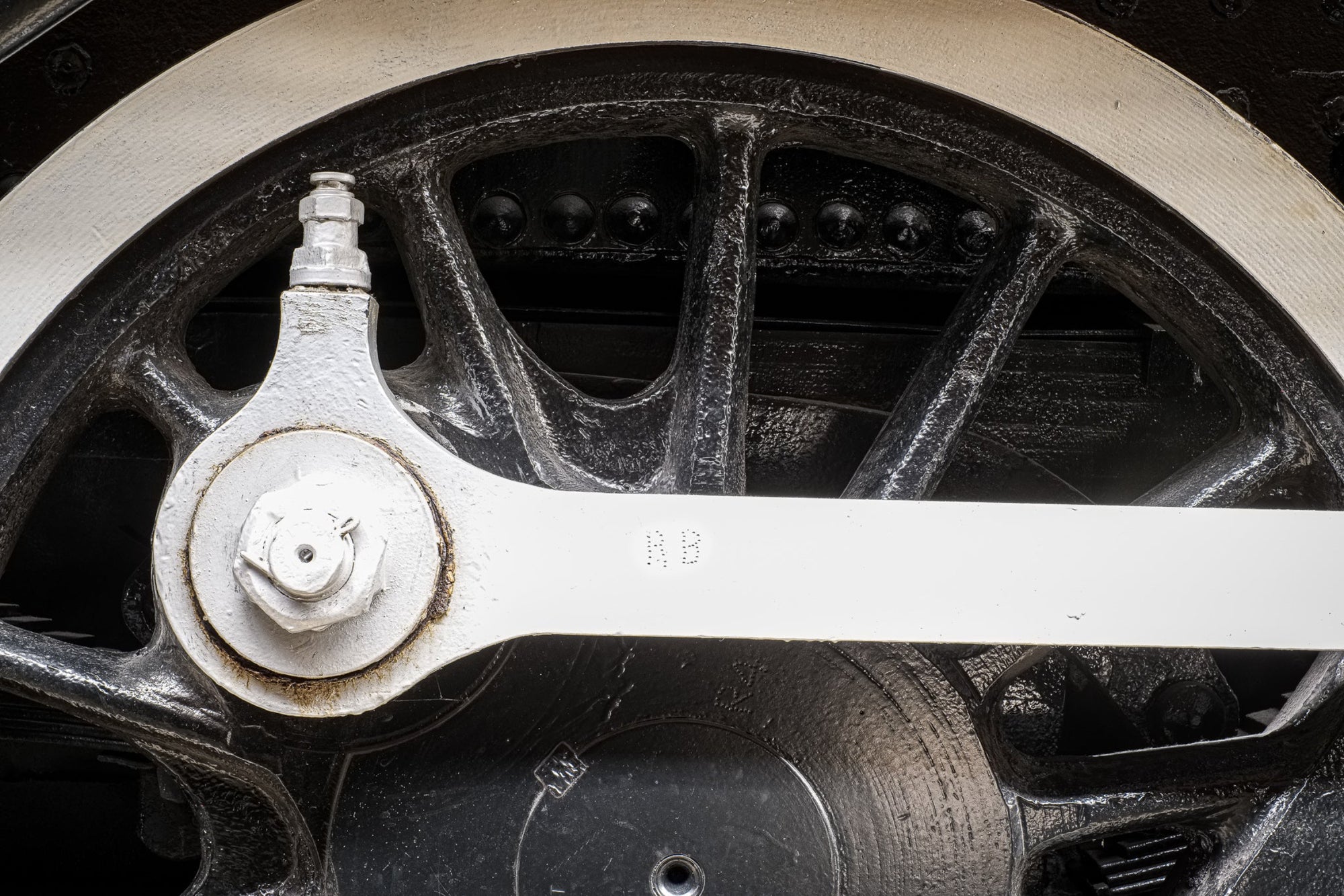 Rick Graves' precisionist photo of components of a vintage railroad locomotive wheel stamped RB