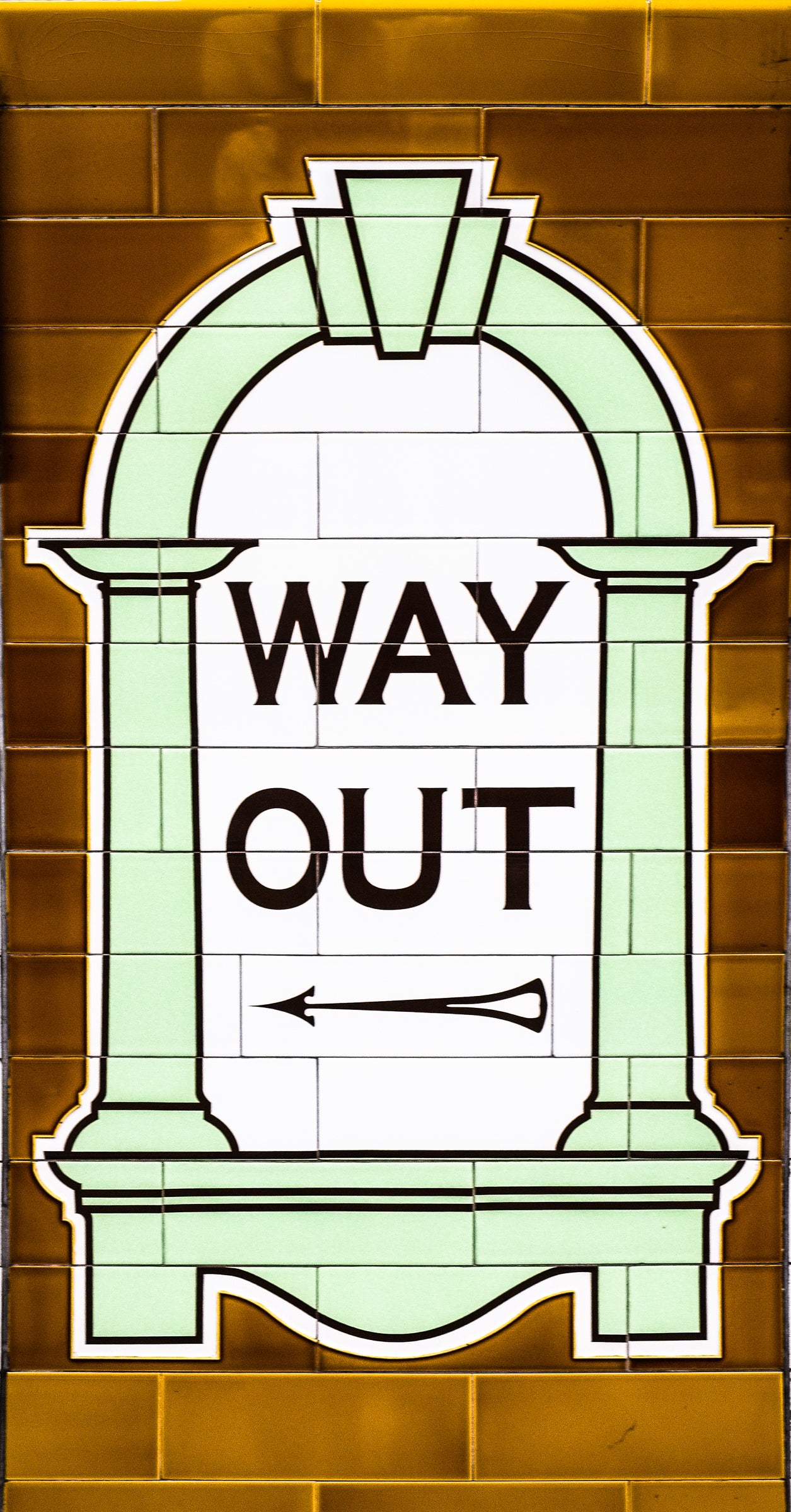 Informational signage with 'WAY OUT' text on a tiled wall background; photographer Rick Graves