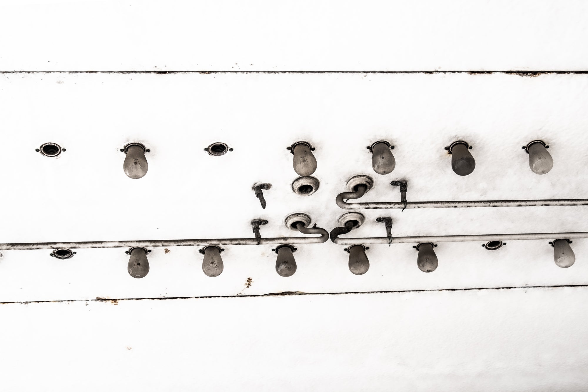 Old overhead exterior movie theatre light bulbs and neon tubes; photographer Rick Graves