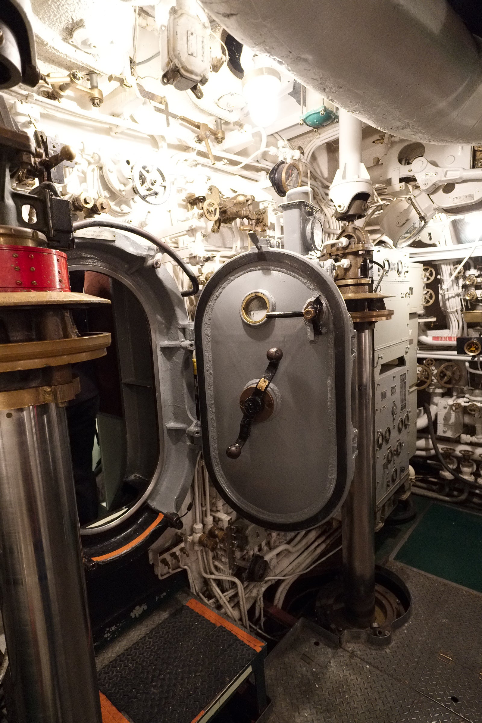 Close-up of mechanical components and open watertight door inside the USS Cobia submarine; photographer Rick Graves