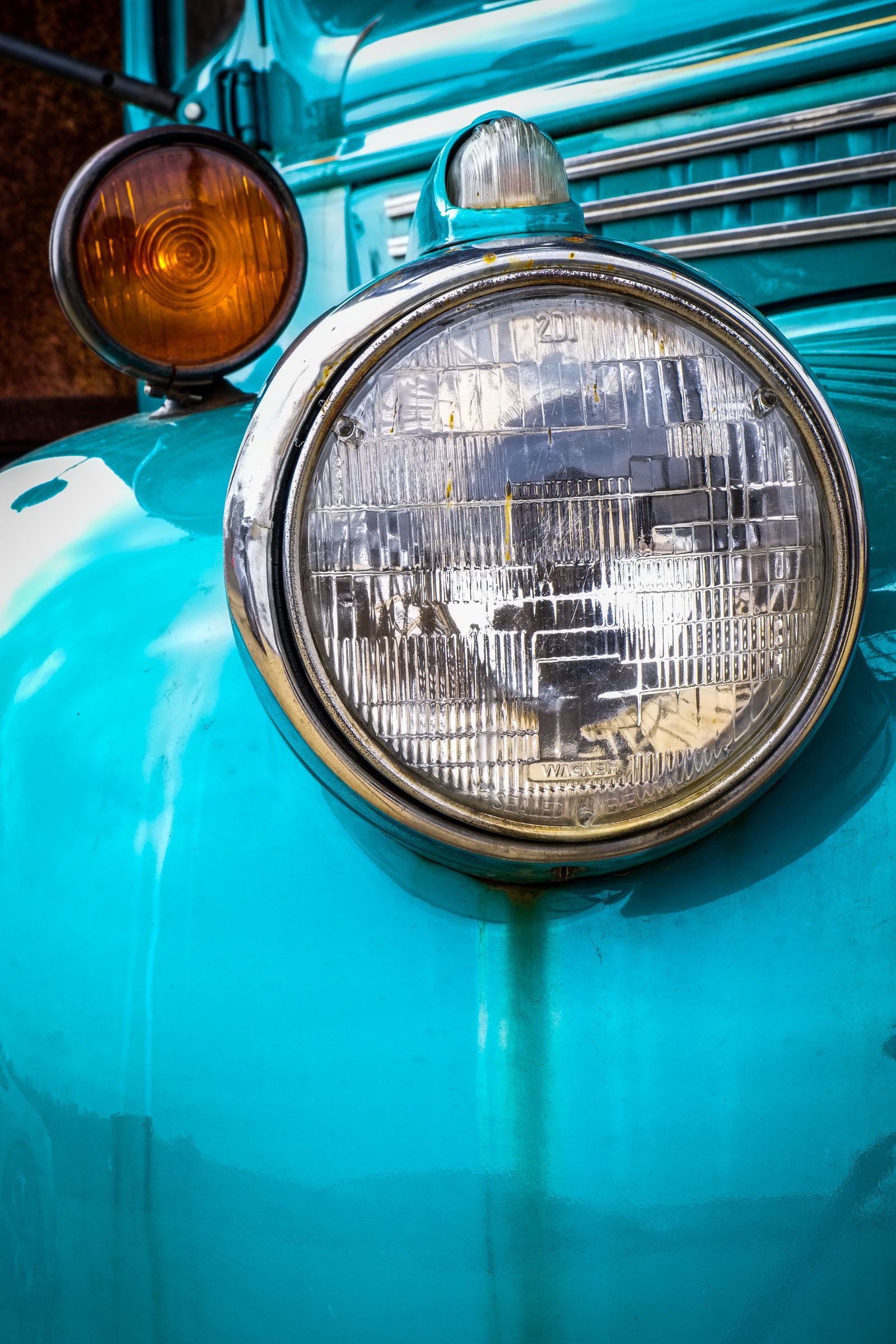 Close-up of a vintage turquoise truck's headlight is part of John Himmelfarb's full-size truck sculpture Penelope; photographed with permission by Rick Graves