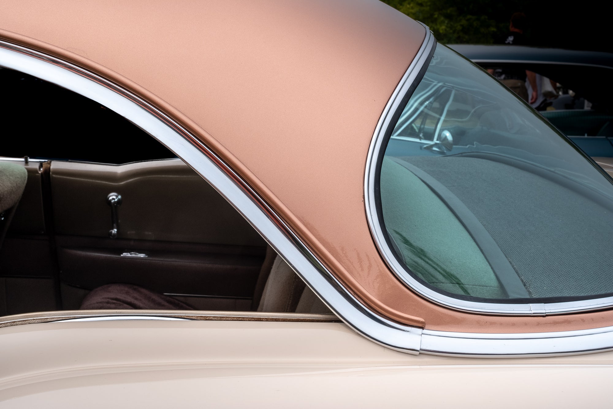 Closeup of the rear-driver's side roof and rear window of a two-tone (copper and cream) 1952 Cadillac; photographer Rick Graves
