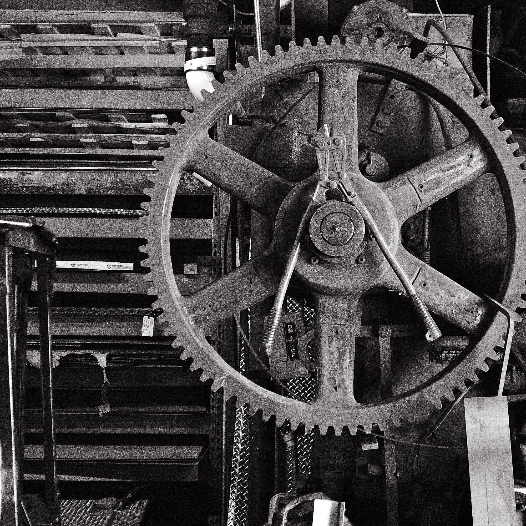 Close-up of a large mechanical gear in an industrial setting; photographer Rick Graves