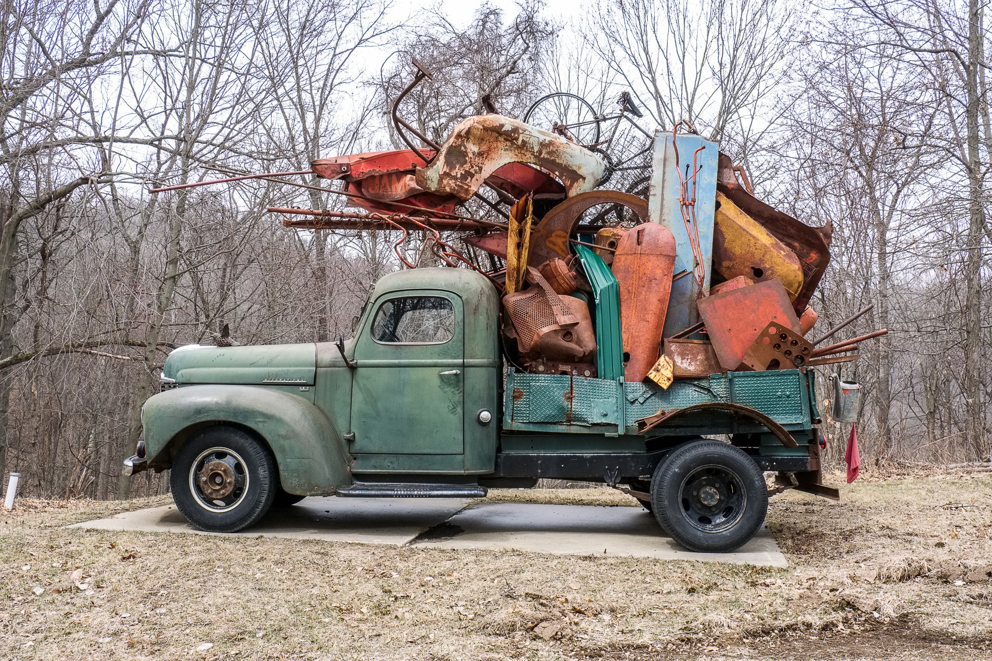 Rust-covered green vintage truck, loaded with scrap metal, is actually a full-size truck sculpture by John Himmelfarb; photographed by Rick Graves with permission of the artist