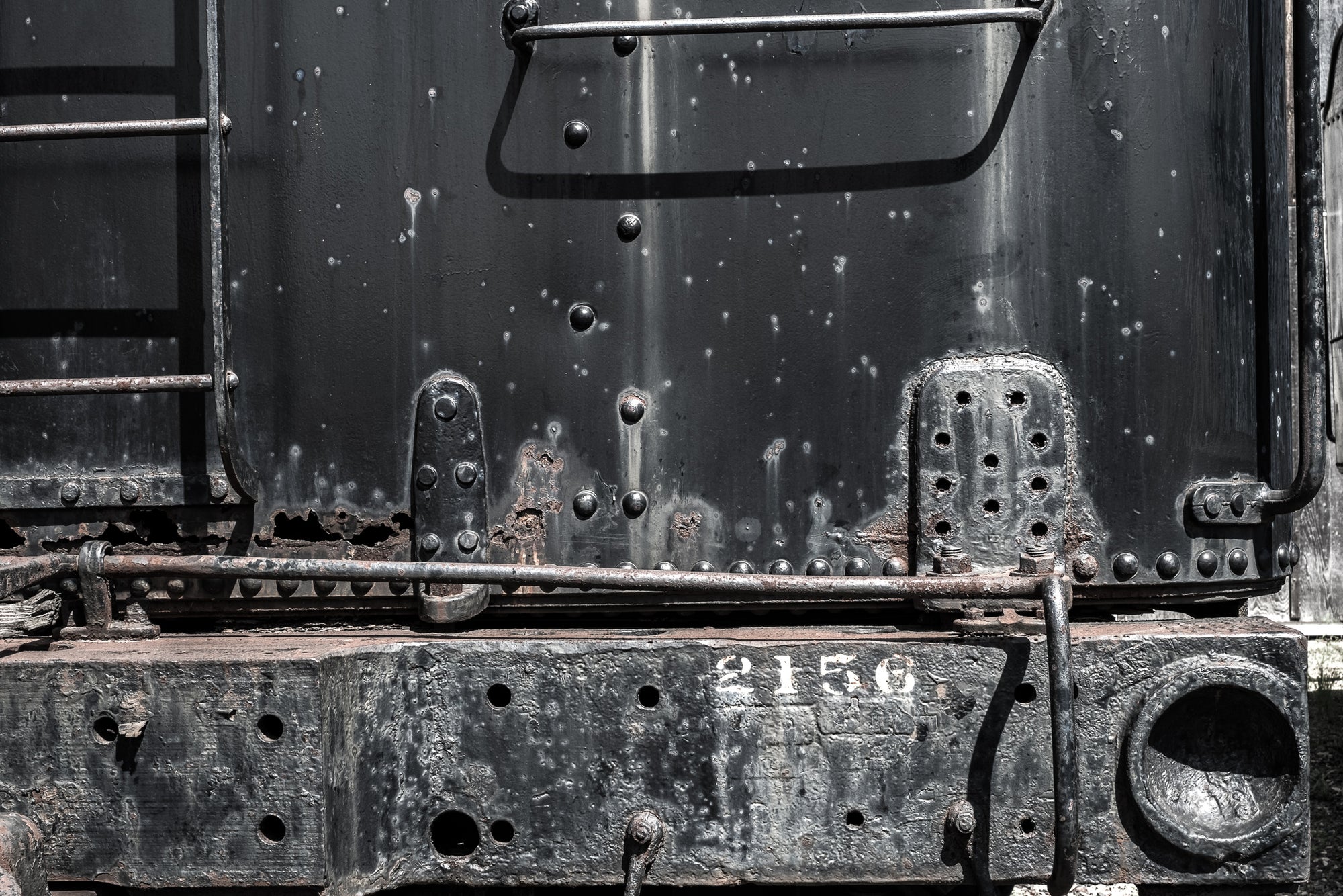 Close-up of an old train coal car (the tender) with visible rust and number 2156; photo by Rick Graves