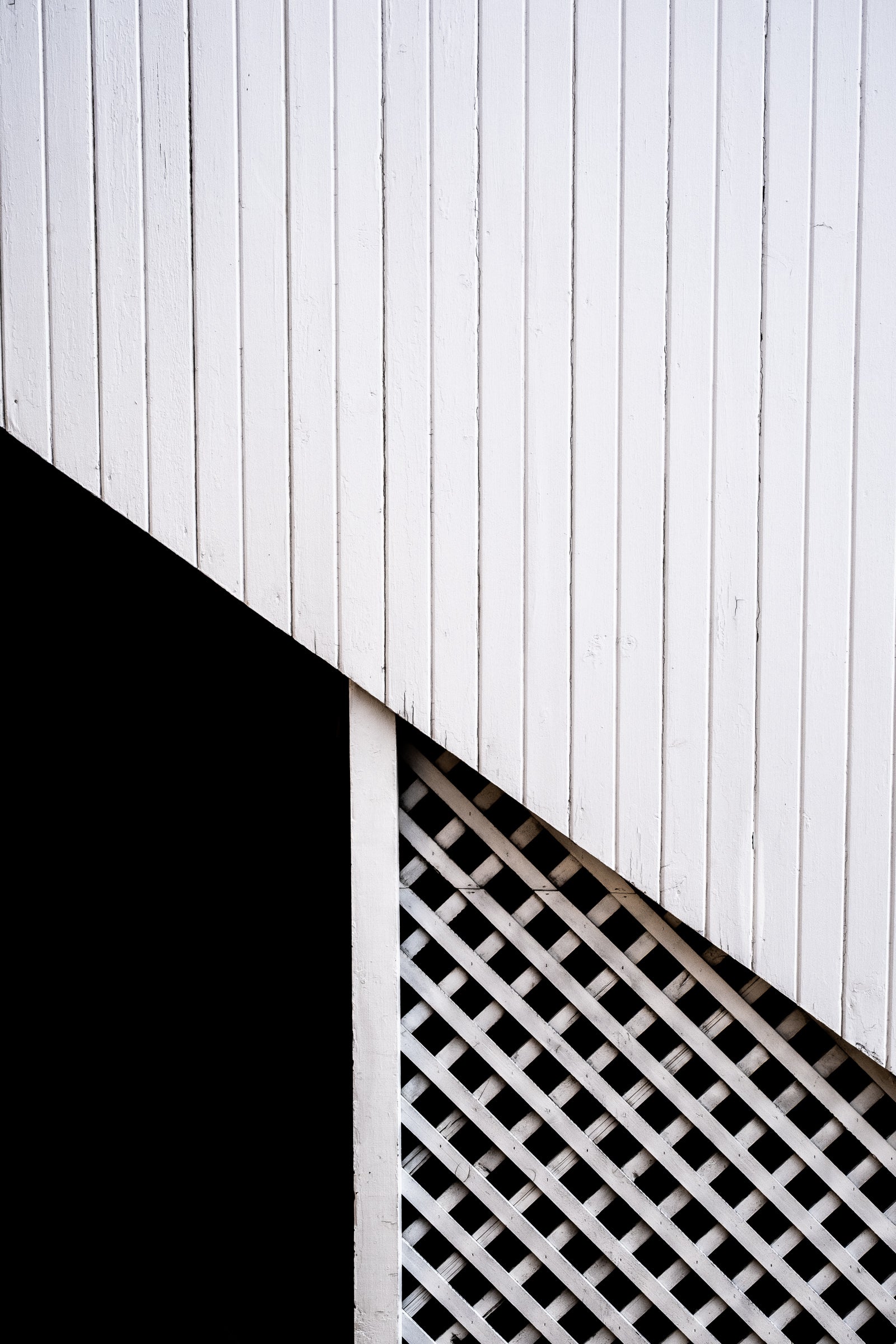 White vertical siding and lattice explores negative space and geometry with a black shadow in precise tension. Every print $25 plus shipping.
