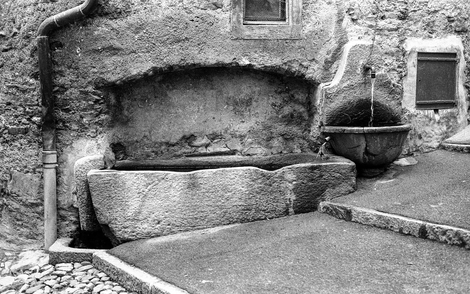 Roman-era stone sarcophagus repurposed as water system infrastructure in Rovio, Switzerland; photographer Rick Graves