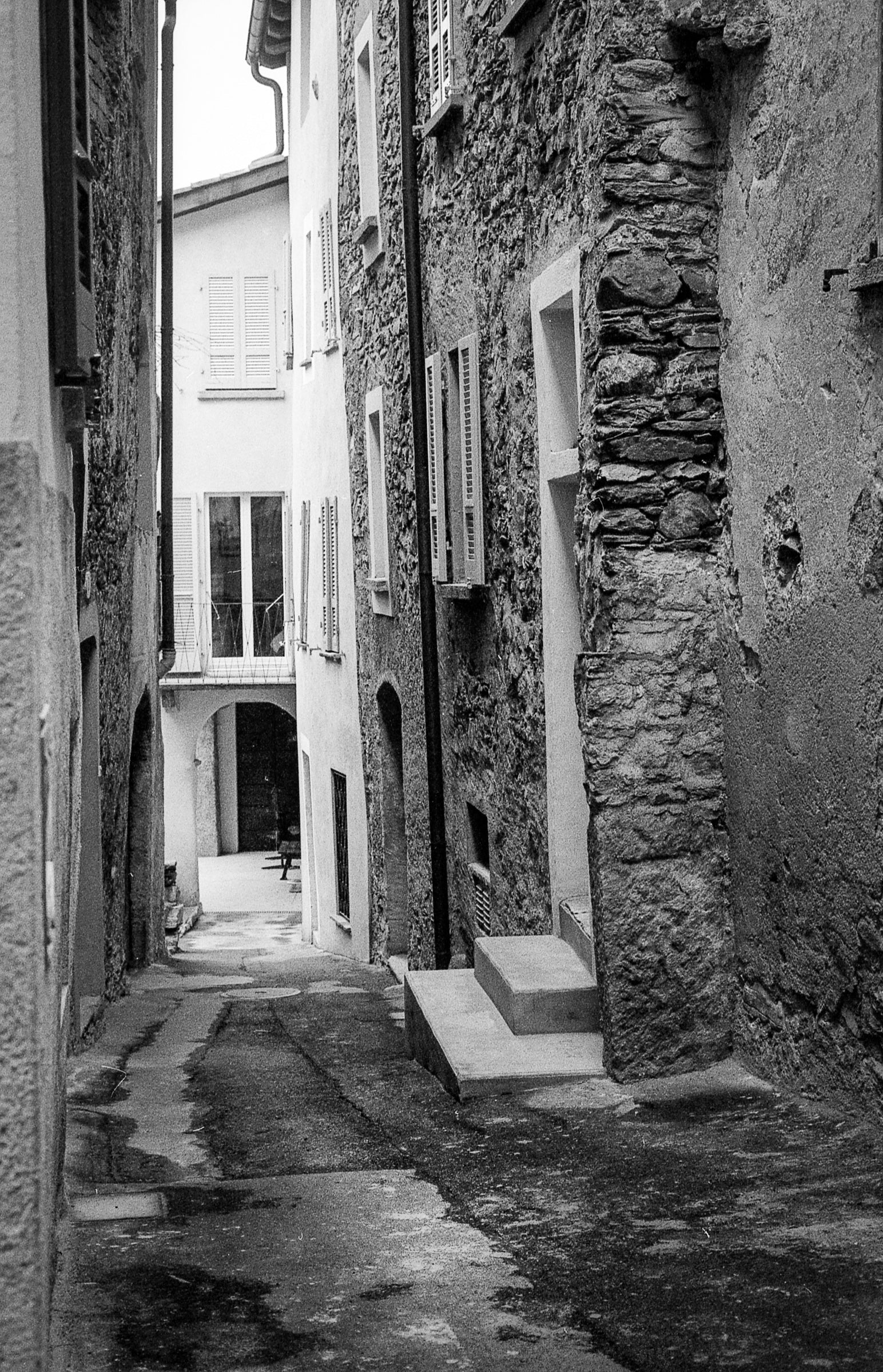 Narrow alleyway between stone buildings in Rovio Switzerland; photographer Rick Graves