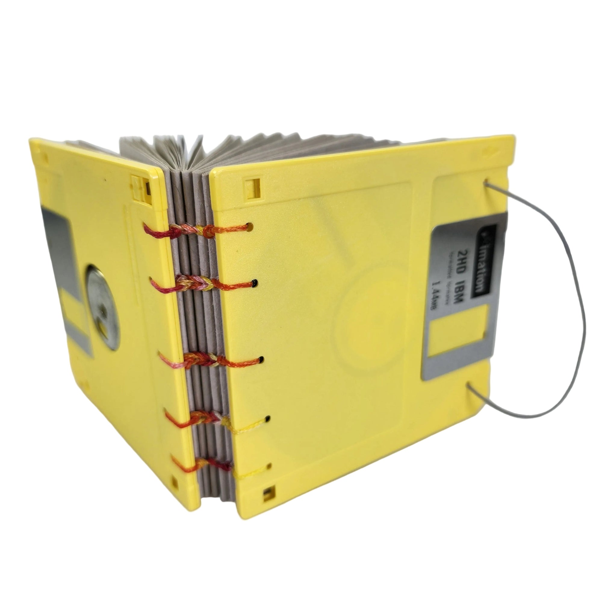 small handmade pocket notebook with yellow vintage 1.44MB diskette covers bound with multi-color polyester thread, 3.5x3.5" 120 blank grey pages, shown on a white background
