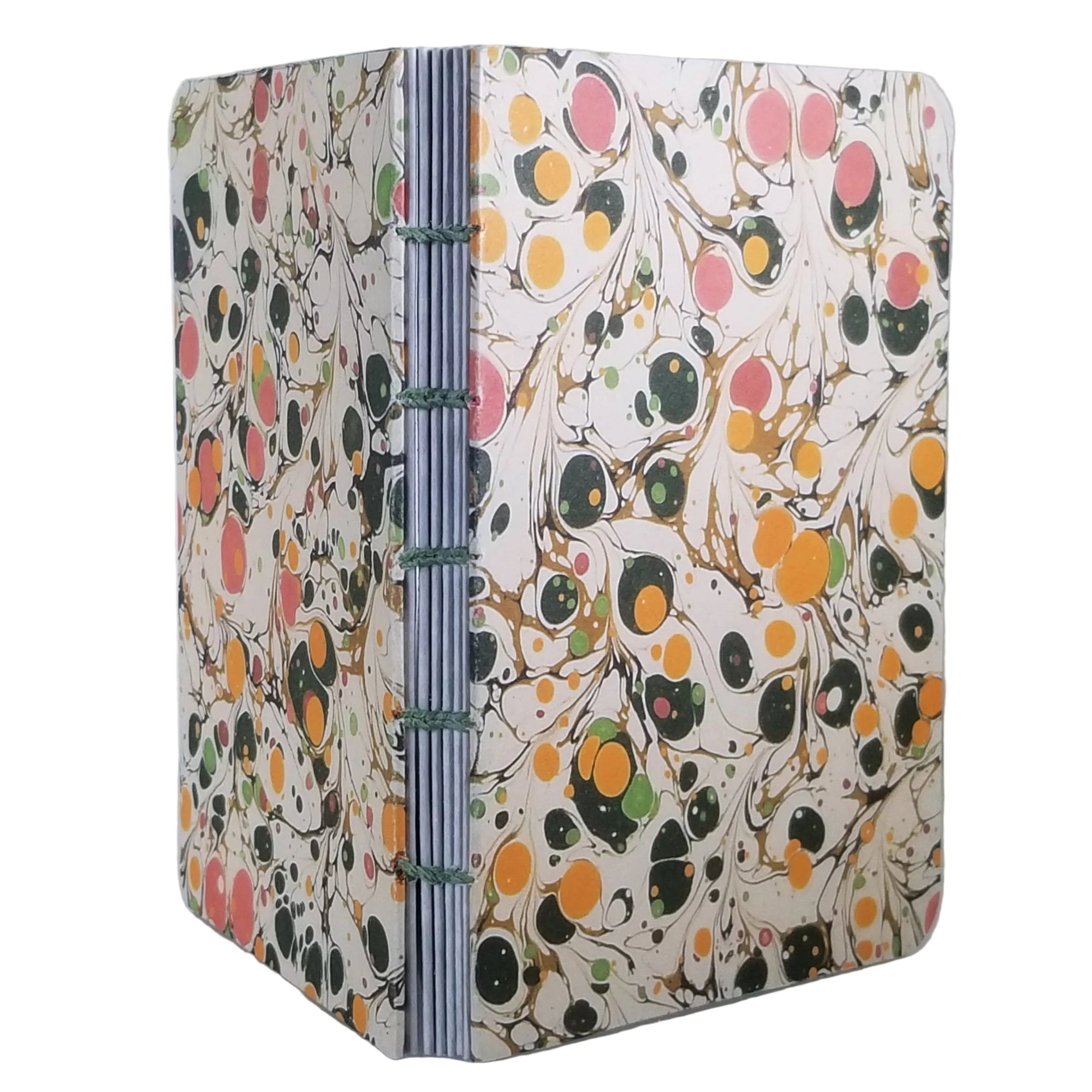 handmade coptic-bound blank notebook with multicolor printed marbled covers in cream, golden yellow, pinks, and greens, bound with green waxed linen thread, ~4x5.5" 96 pages, shown on a white background