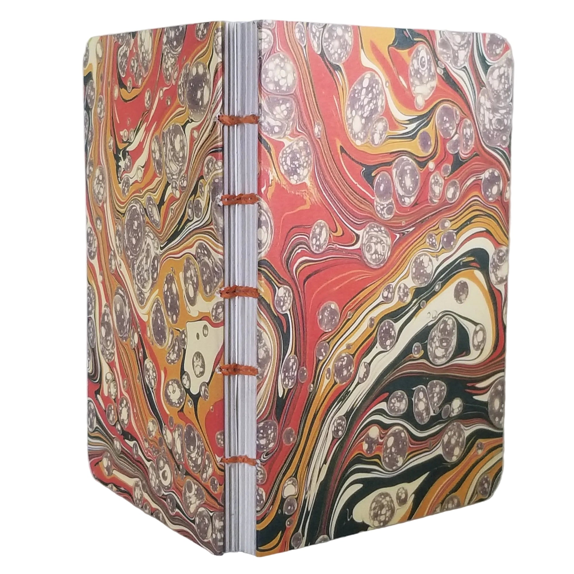 handmade coptic-bound blank notebook with multicolor printed marbled covers in orange, gold, cream, and dark green, bound with rust-orange waxed linen thread, ~4x5.5" 96 pages, shown on a white background