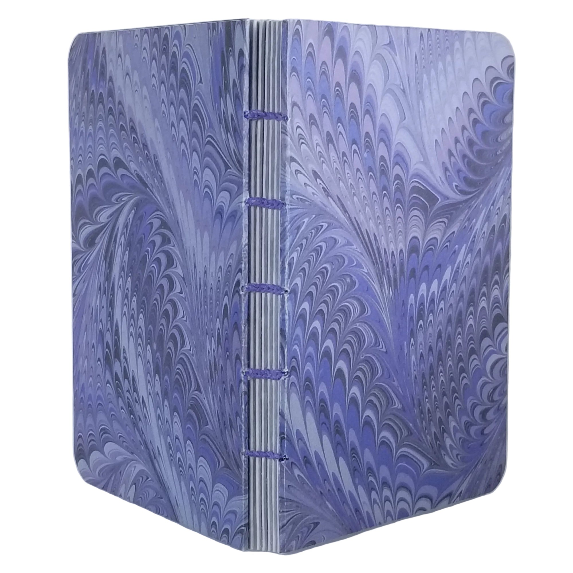 handmade small blank journal with predominantly lavender and purple printed paper in a marbling pattern, exposed spine, and light purple thread, ~4x5.5" 96 pages, shown on a white background
