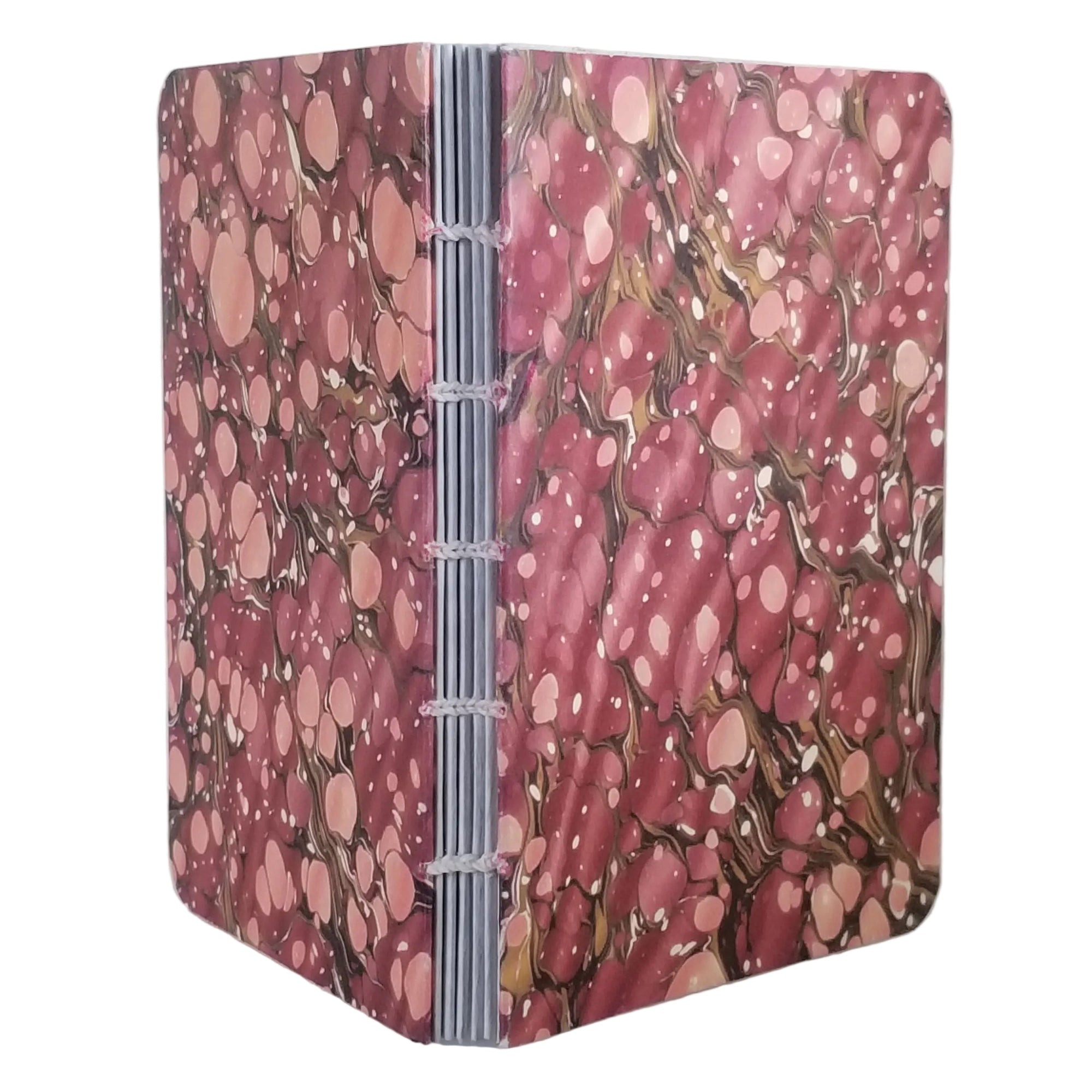 handmade coptic-bound blank notebook with multicolor printed marbled covers dusty reds with taupe rivulets, bound with off-white waxed linen thread, ~4x5.5" 96 pages, shown on a white background
