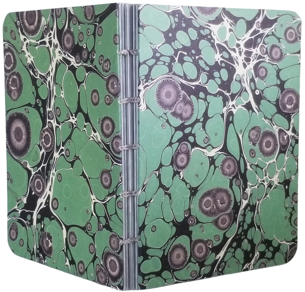 handmade small blank journal with predominantly green and black printed paper marbling pattern, exposed spine, and light grey thread, shown on a white background
