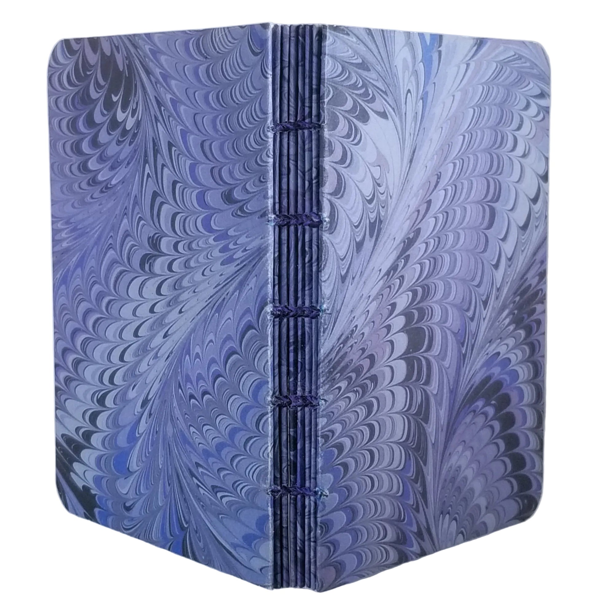 handmade small blank journal with predominantly blue and grey printed paper marbling pattern, exposed spine showing matching paper detailing, and variegated thread in matching colors, ~4x5.5" 96 pages, shown on a white background