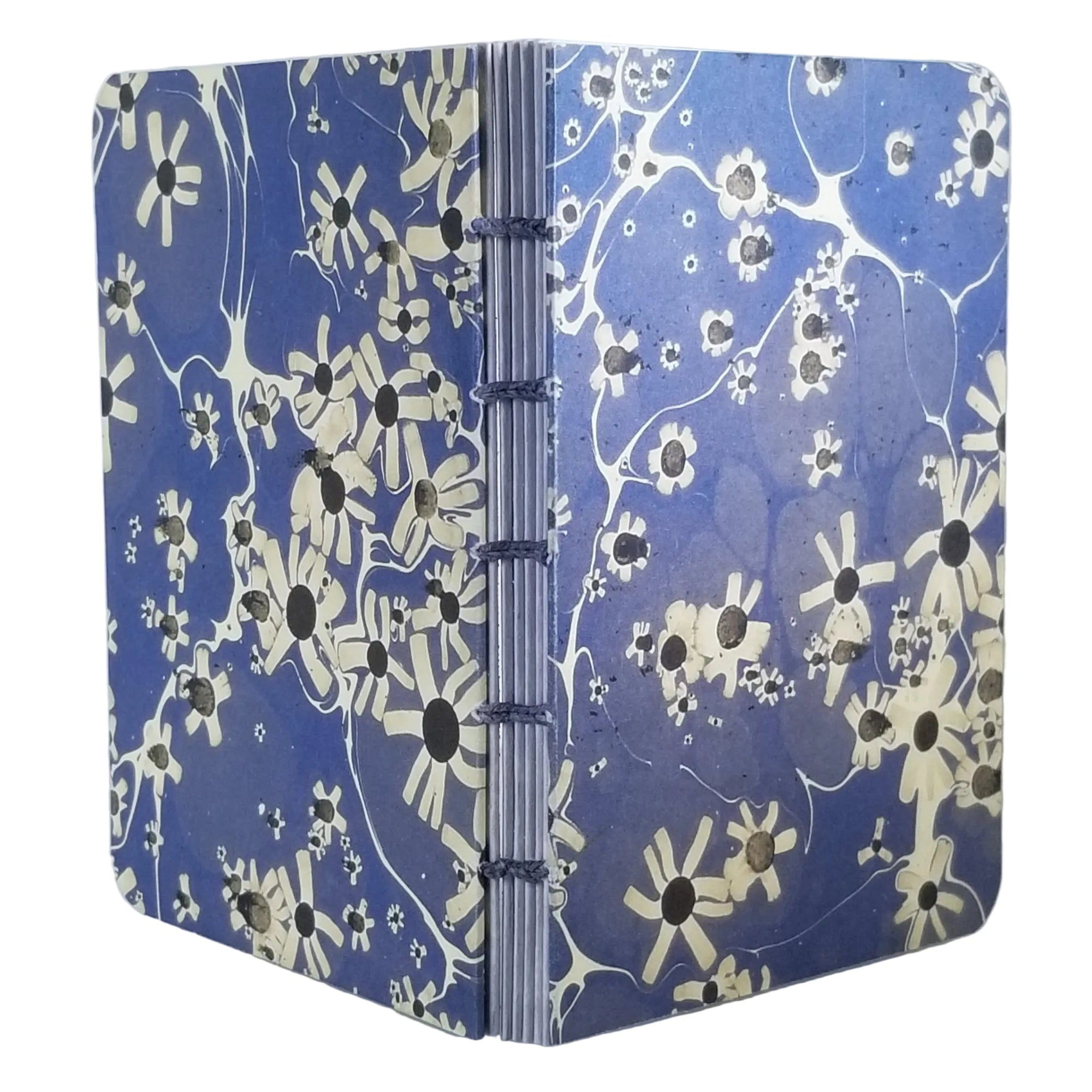 handmade small blank journal with predominantly blue and cream printed paper marbling pattern, exposed spine, and light blue thread, ~4x5.5" 96 pages, shown on a white background