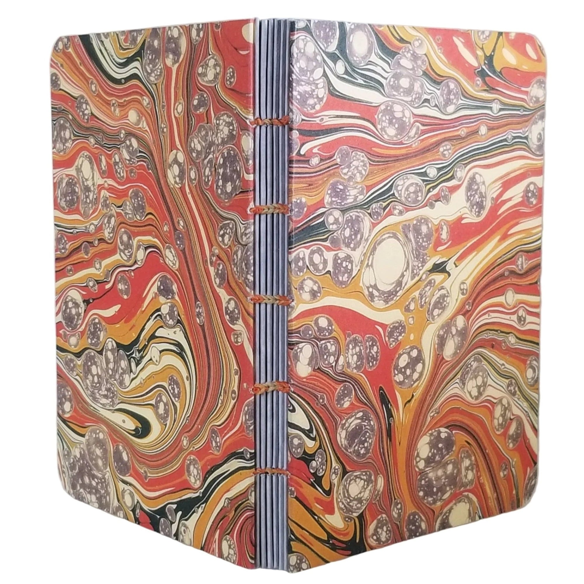 handmade coptic-bound blank notebook with orange, gold, and green printed marbled covers and variegated thread in matching colors, ~4x5.5" 96 pages, shown on a white background